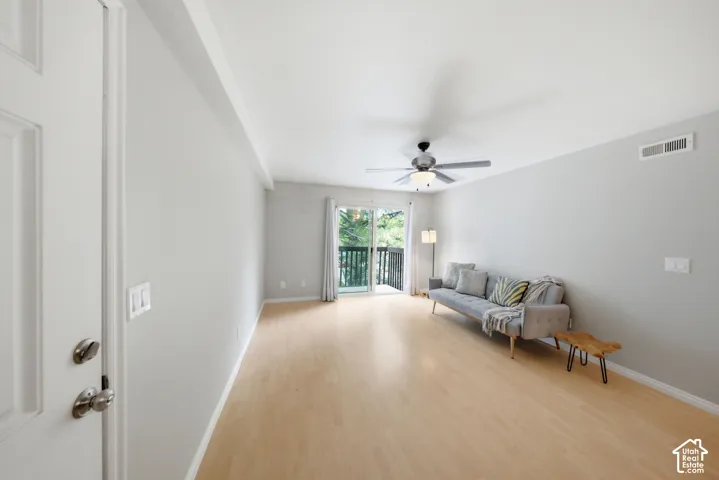 Open-concept room featuring light wood-finish flooring and light gray walls