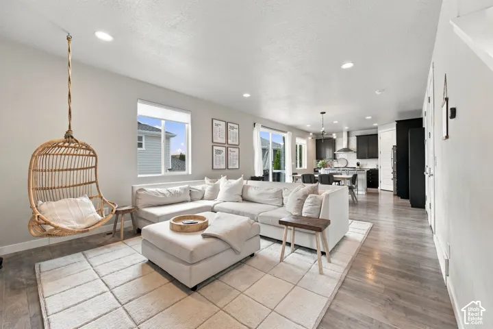 Open floor plan featuring wood-finish flooring, recessed lighting, and expansive windows