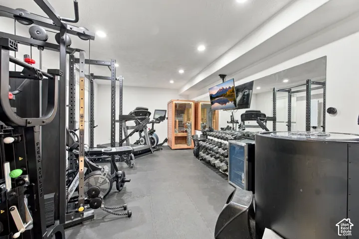 Room featuring recessed lighting, wall-to-wall mirror, and specialized flooring