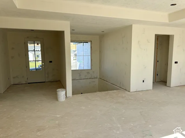Living room showing layout to the entry, downstairs, and laundry