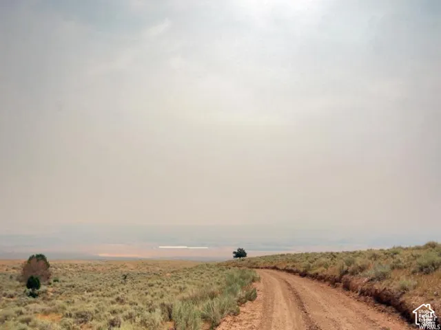 View of dirt / gravel road featuring a view of countryside