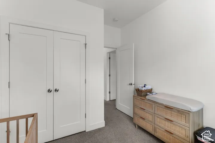 Interior featuring double-panel closet doors, neutral wall finish, and low-pile carpeting
