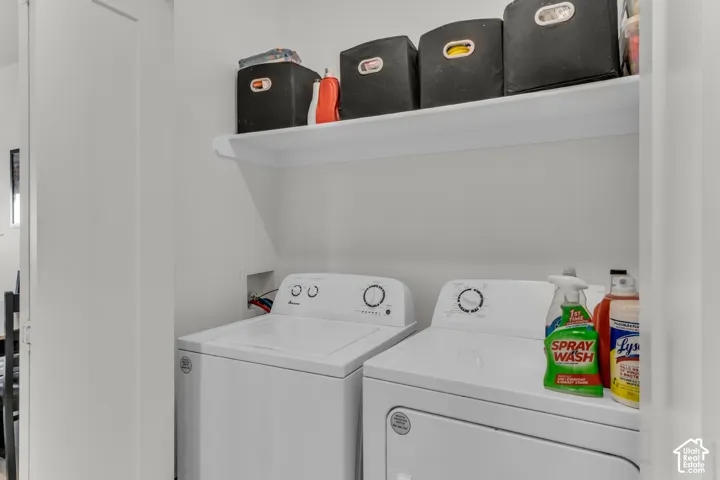 Laundry area featuring a dedicated white appliance alcove and a built-in overhead storage shelf