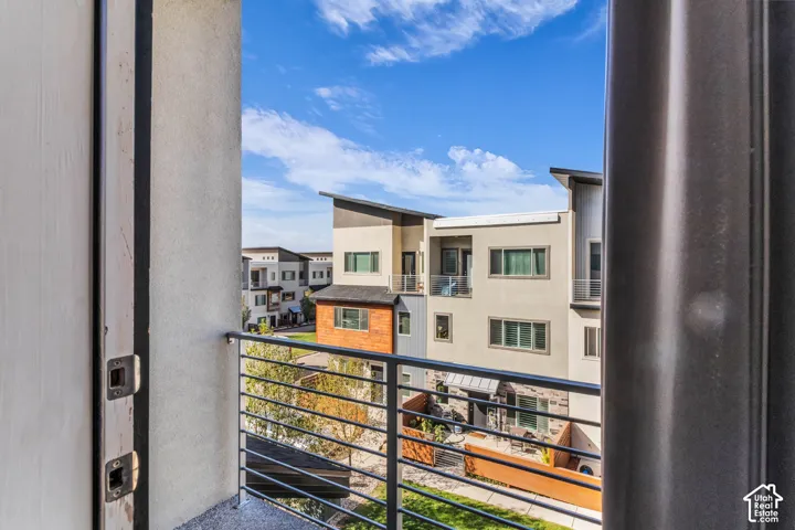 Private balcony featuring horizontal metal railings and a concrete surface