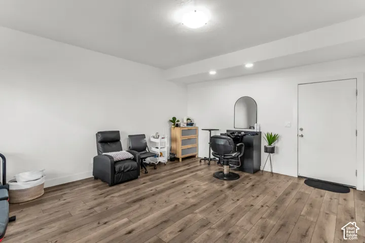 Interior space featuring wood-finish flooring, white walls, and recessed lighting