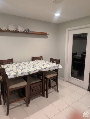 Tile flooring, mounted wooden wall shelf, and glass-paneled entry door