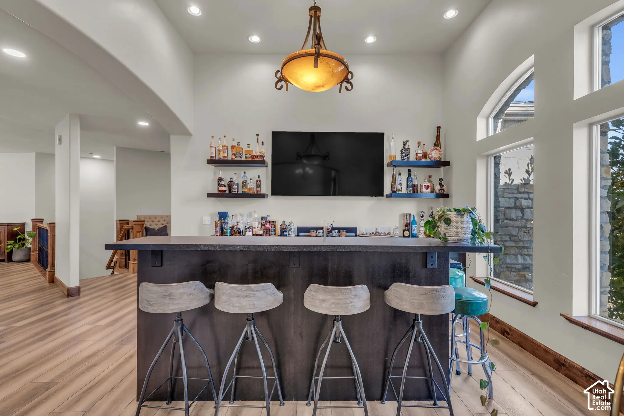 Integrated wet bar with dark wood finish cabinetry and a contrasting countertop