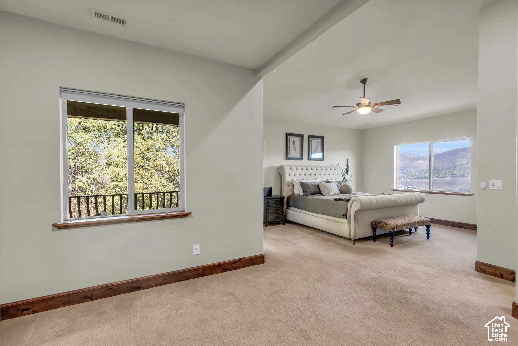Plush carpet flooring complements pale wall finishes and natural wood trim