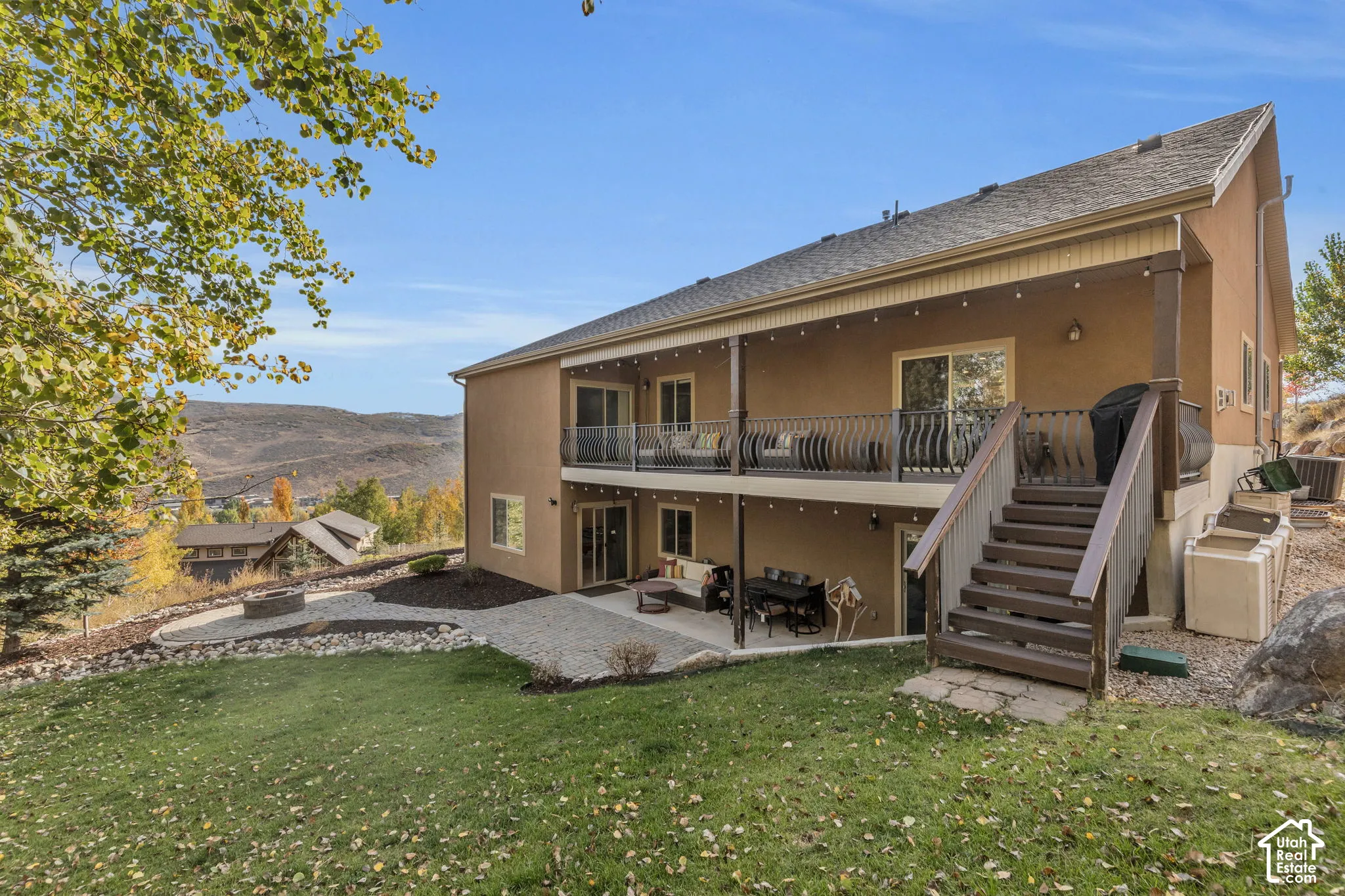 Multi-level outdoor living spaces with a covered upper deck and lower patio