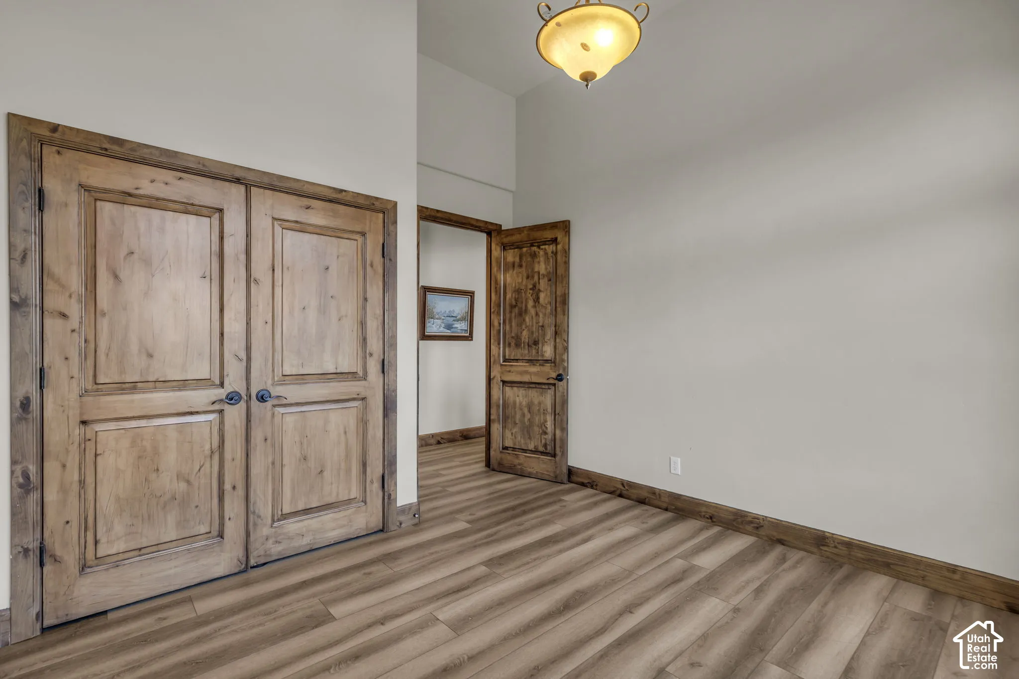 Wood-finish flooring with coordinating wood trim and solid wood panel doors
