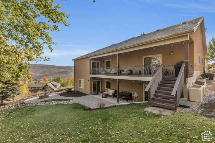 Multi-level outdoor living spaces with a covered upper deck and lower patio