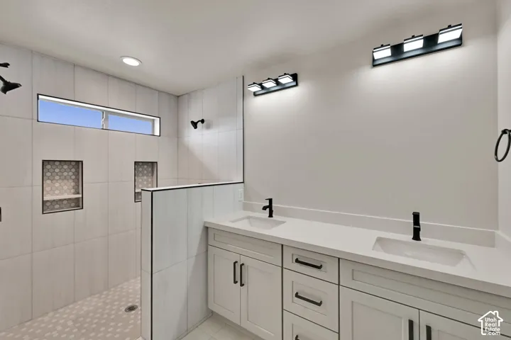 Dual vanity featuring white shaker-style cabinetry, quartz countertops, and matte black hardware