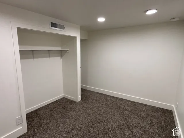 Recessed lighting, white trim, and plush carpet flooring
