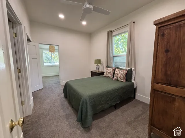 Neutral wall color, recessed lighting, ceiling fan, and carpeted flooring
