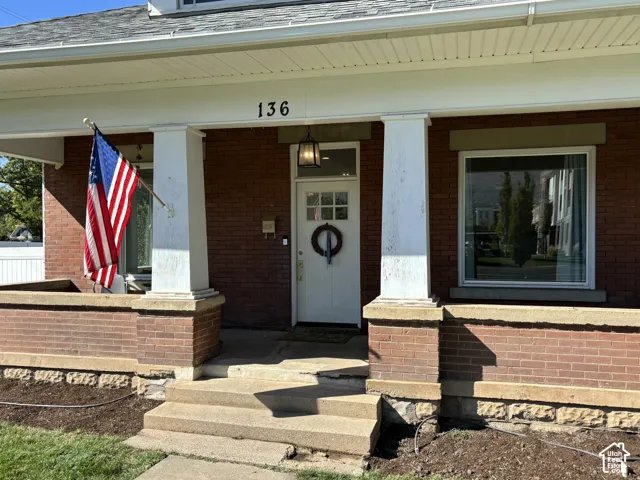 Brick exterior with a covered porch featuring two square columns