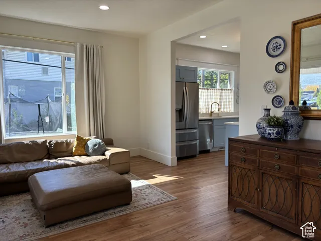 Hardwood-finish flooring throughout, recessed ceiling lighting, and a wide window offering ample natural light