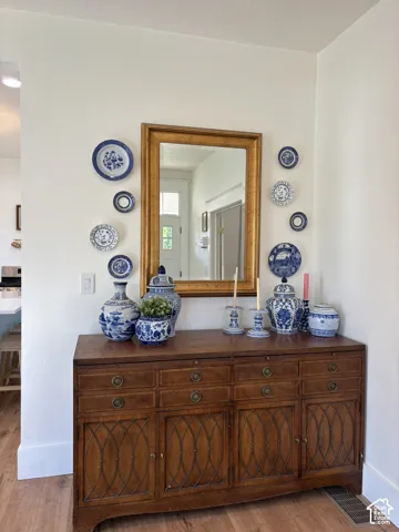 Wood-finish flooring with white wall trim