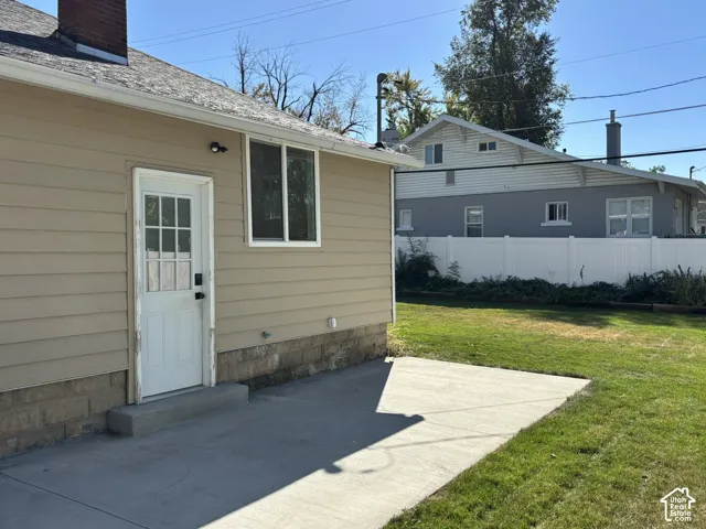 Siding exterior with a white paneled door featuring multiple glass inserts