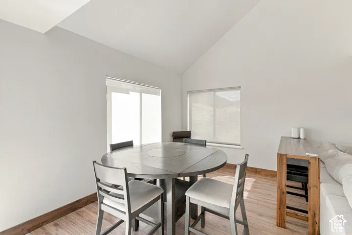 Vaulted ceilings, wood-finish flooring, and natural light provided by dual windows