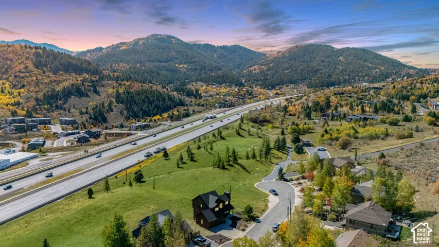 Aerial perspective of property featuring mountainous topography, expansive terrain, and mature coniferous trees