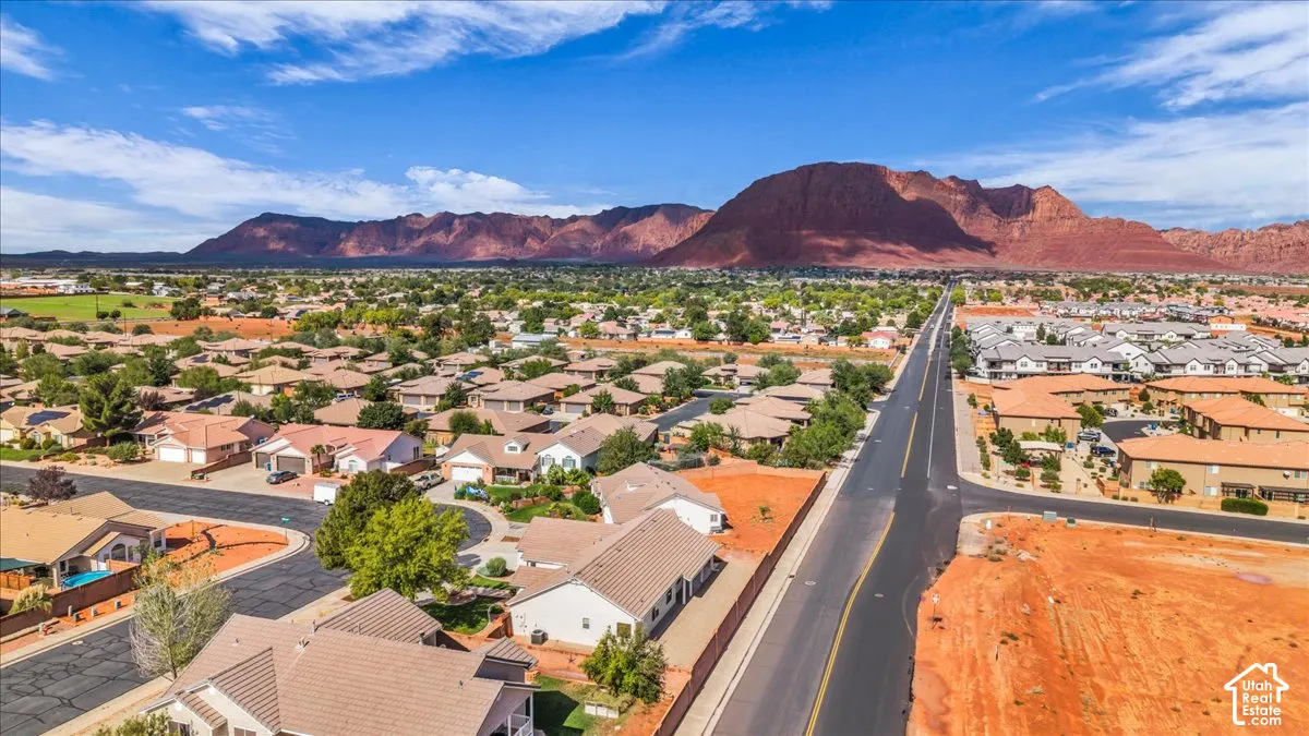 Aerial perspective featuring residential lots and prominent red rock mountain backdrop