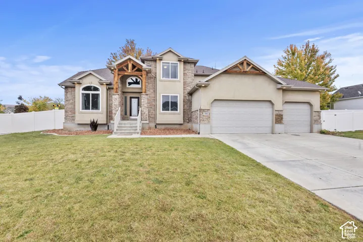 Multi-level exterior featuring a stone and stucco fa
