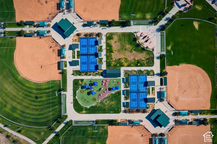 Public recreational complex featuring four baseball diamonds, paved pathways, multiple tennis courts, and a central parking area