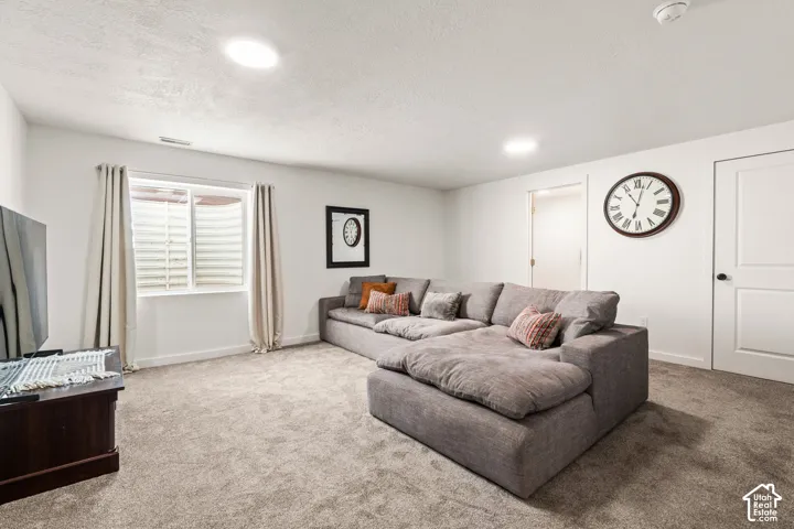 Fully finished basement featuring carpeted flooring, recessed ceiling lighting, and a three quarter bathroom.