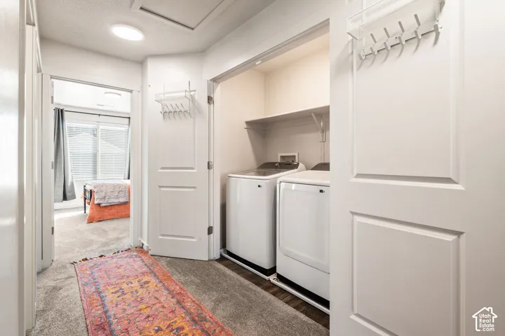 Laundry alcove featuring a built-in shelf and double-panel doors