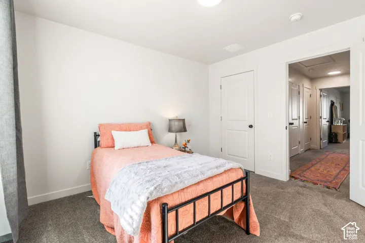Neutral-toned interior featuring wall-to-wall carpeting, crisp white walls, and multi-panel interior doors with matte black hardware
