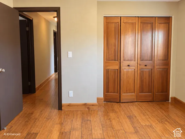 Wood-finish plank flooring throughout, featuring a closet with four-panel wood-finish bifold doors and a neutral wall color palette