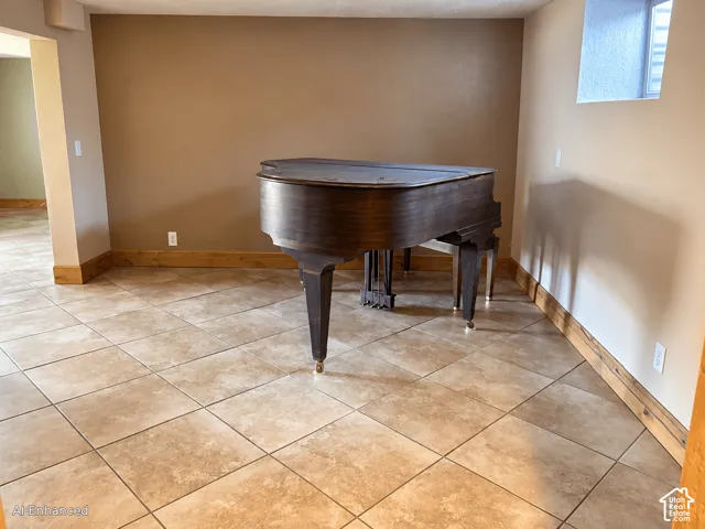 Large-format ceramic tile flooring, neutral wall tones, and natural wood-finish trim