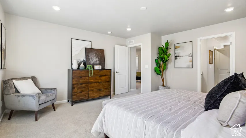 Neutral wall color, recessed lighting, carpeted flooring, and multi-panel interior doors