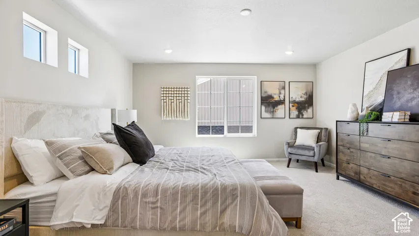 Spacious room featuring neutral carpeting, recessed ceiling lighting, and multiple windows providing natural light