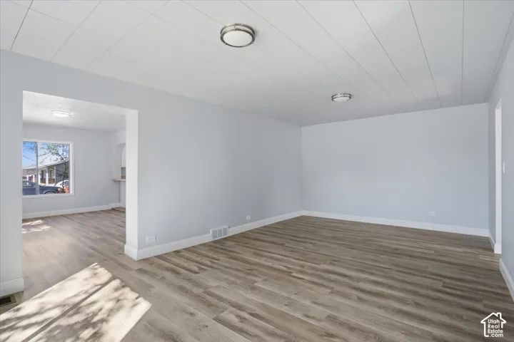 Neutral-toned interior featuring wood-finish flooring, white panel ceiling, and brushed nickel flush-mount lighting fixtures