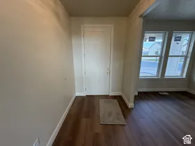 Entryway featuring wood-finish flooring, a solid-panel door, and expansive windows