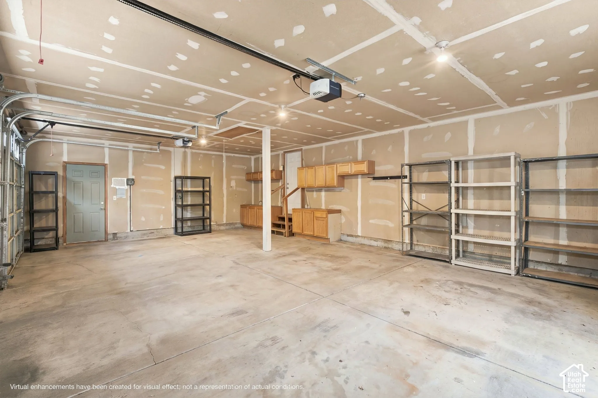 Attached multi-car garage featuring concrete flooring, built-in wooden cabinetry, recessed ceiling lighting, and overhead garage door opener