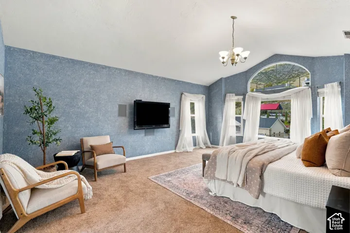 Vaulted ceilings, arched windows, and multi-light chandelier featuring a textured blue wall finish
