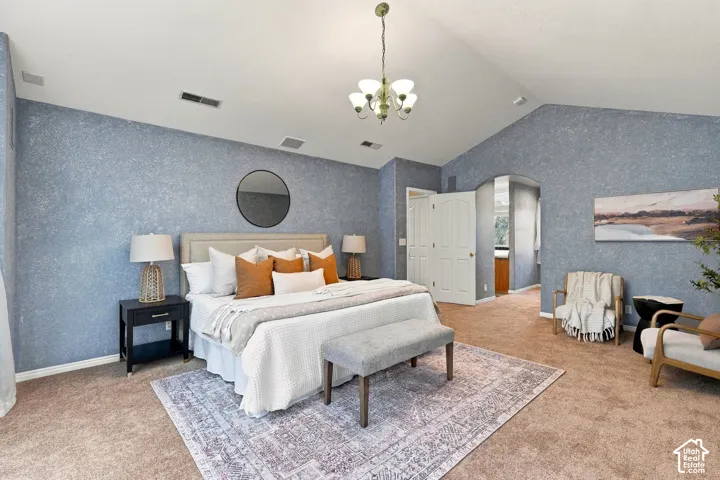Vaulted ceilings, textured wall finish, and multi-arm chandelier fixture