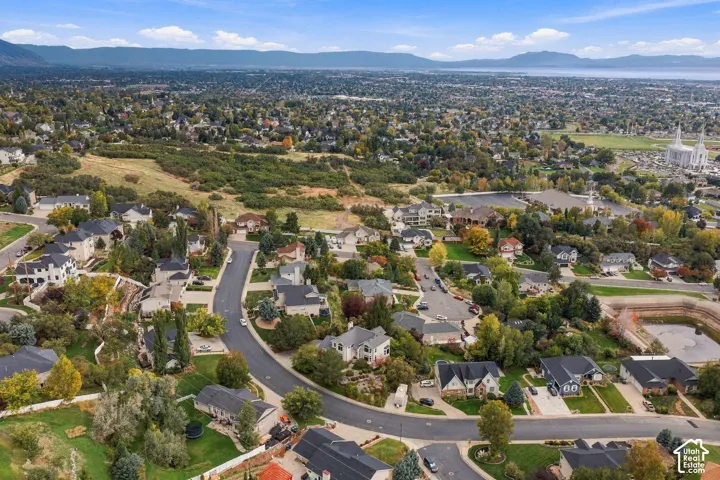 Aerial perspective featuring rolling mountain topography, expansive valley landscape, and mature deciduous trees