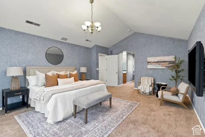 Vaulted ceilings, textured wall finish, and an arched entry