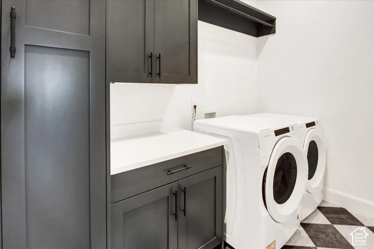 Charcoal shaker-style cabinetry with matte black hardware, white countertop, under-cabinet lighting, and checkerboard floor tiles