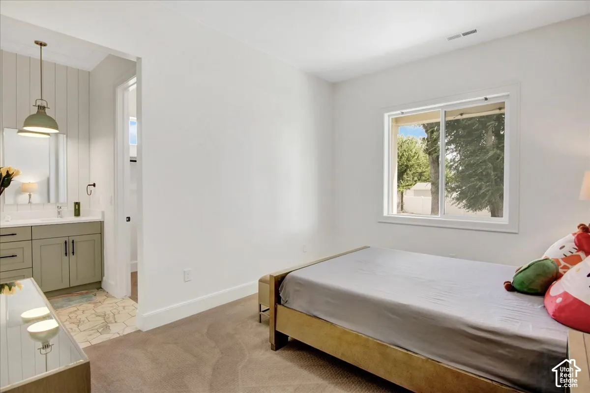 Bedroom featuring carpeting, white walls, and a window with white trim