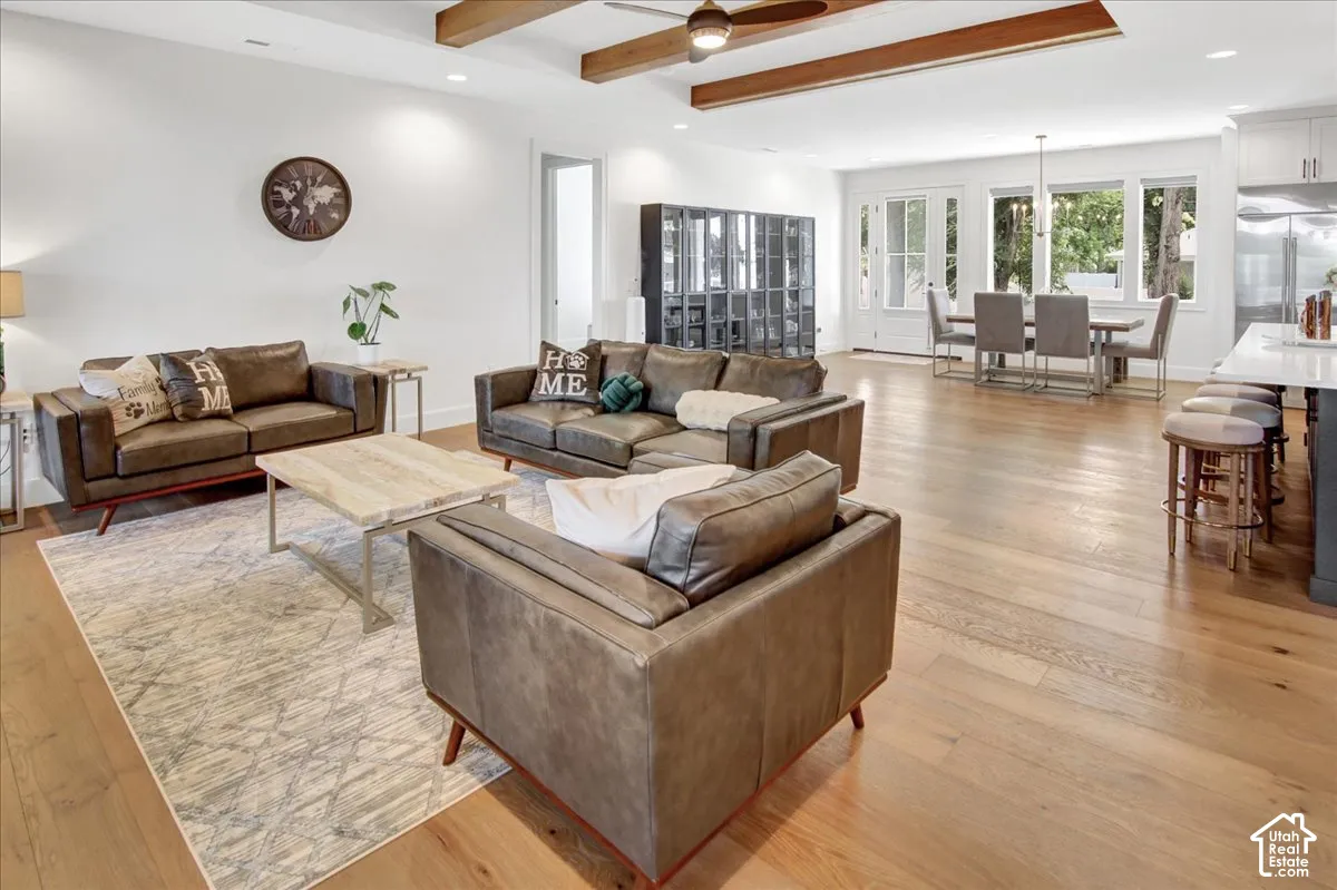 Expansive wood-finish flooring throughout, complemented by exposed wood ceiling beams