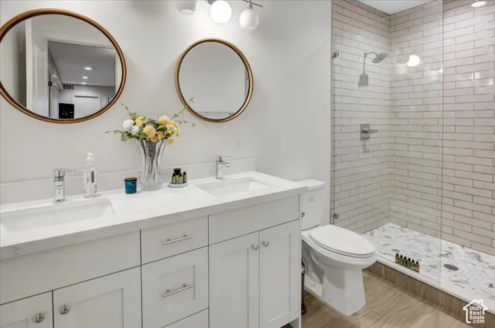 Double vanity with white cabinetry, dual undermount sinks, and polished chrome faucets
