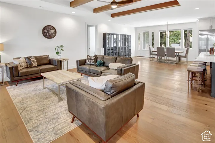 Expansive wood-finish flooring throughout, complemented by exposed wood ceiling beams