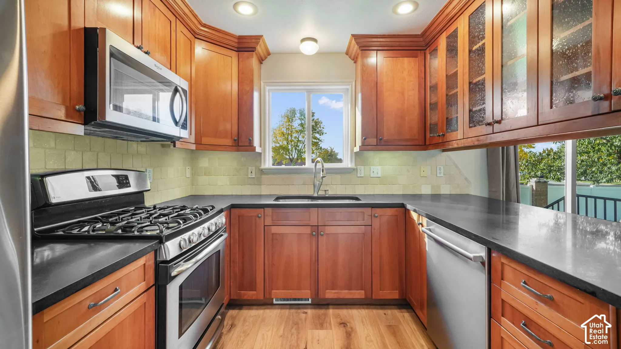 Kitchen with honed granite countertops and custom cherry hardwood cabinets