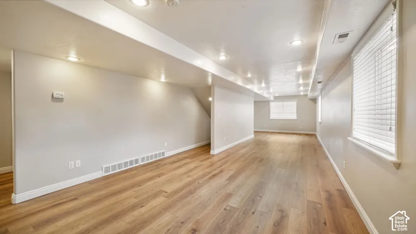 Spacious family room in basement with a lot of natural light