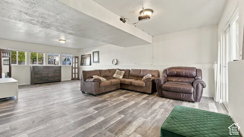 Interior space featuring wood-finish flooring, four windows, and sliding glass doors