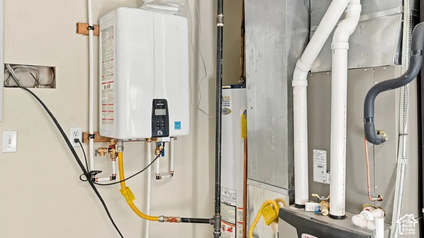 Tankless water heater, secondary water heating unit, and forced-air heating system featuring metal ductwork and integrated plumbing